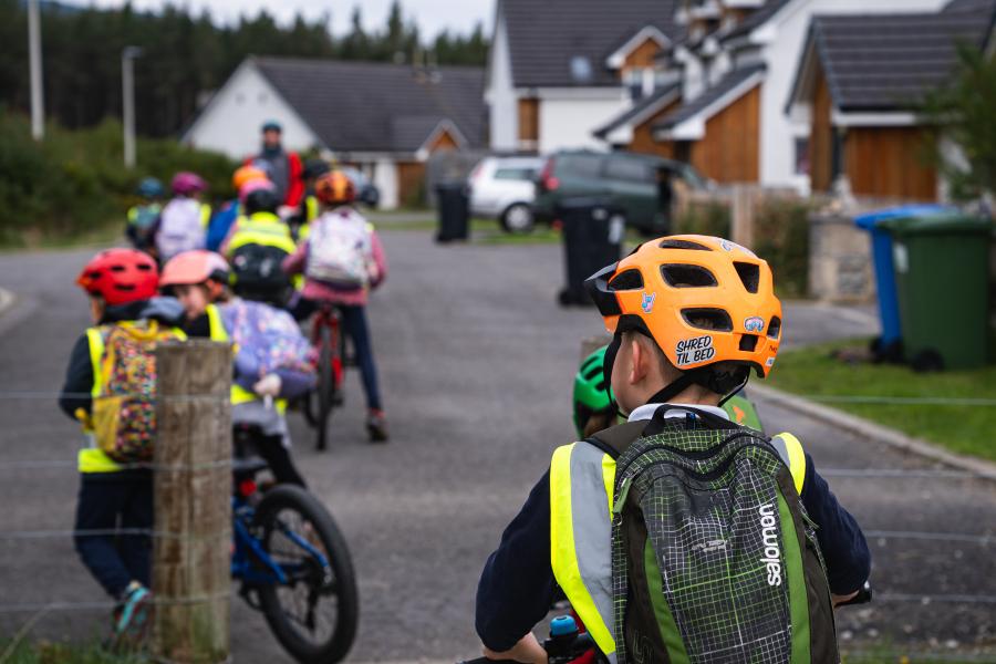 Children getting ready to set off on their bikes to ride to school