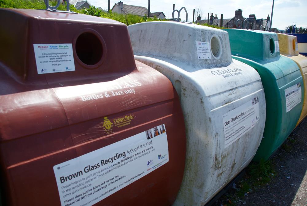 Four glass recycling bins