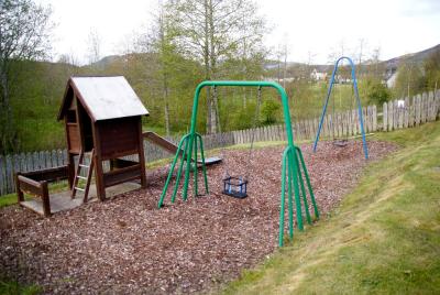 play park showing two swings and a slide.