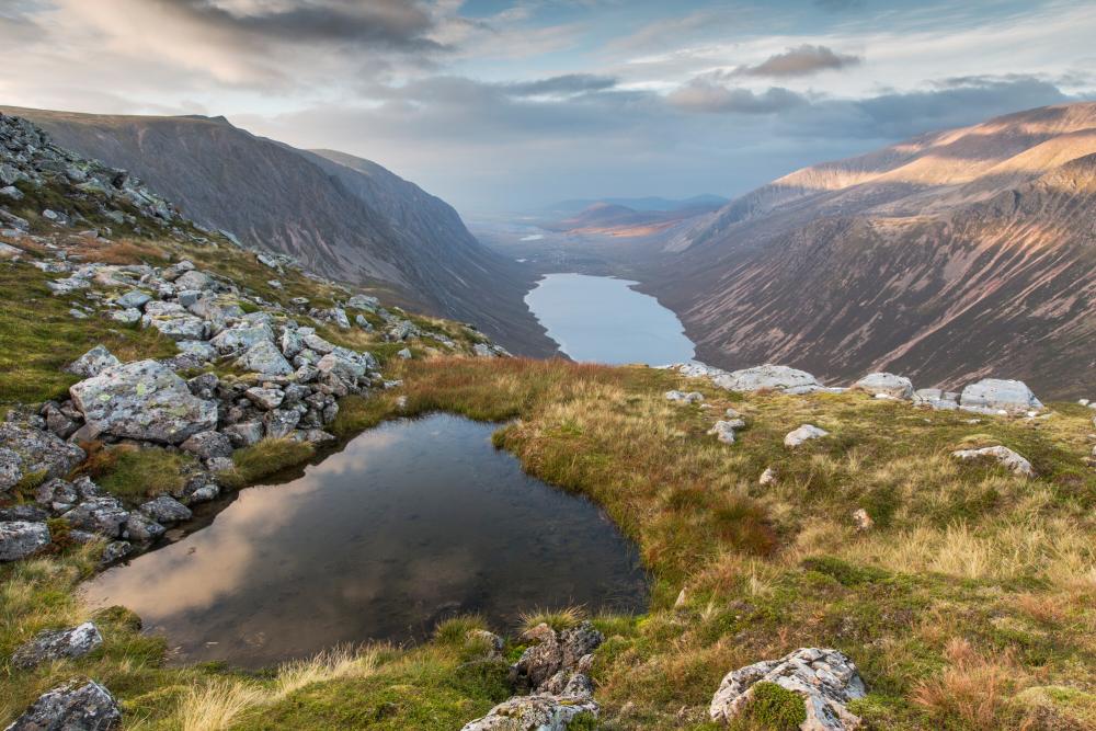 View over Glen Einich in late summer. Looking down on loch Einich with steep mountains on either side.