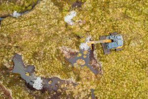 An aerial view of a digger on peatland.
