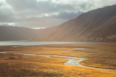 Sunlight over a river and loch