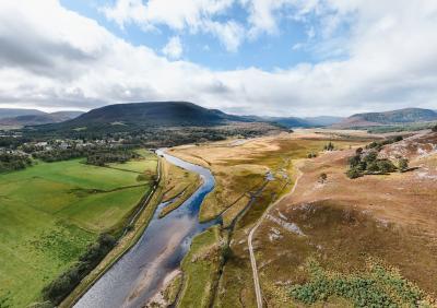 Aerial view of the River Dee and surrounding wetland , fields and mountains