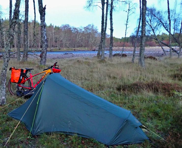 Bike and tent amongst trees, near the River Dulnain.