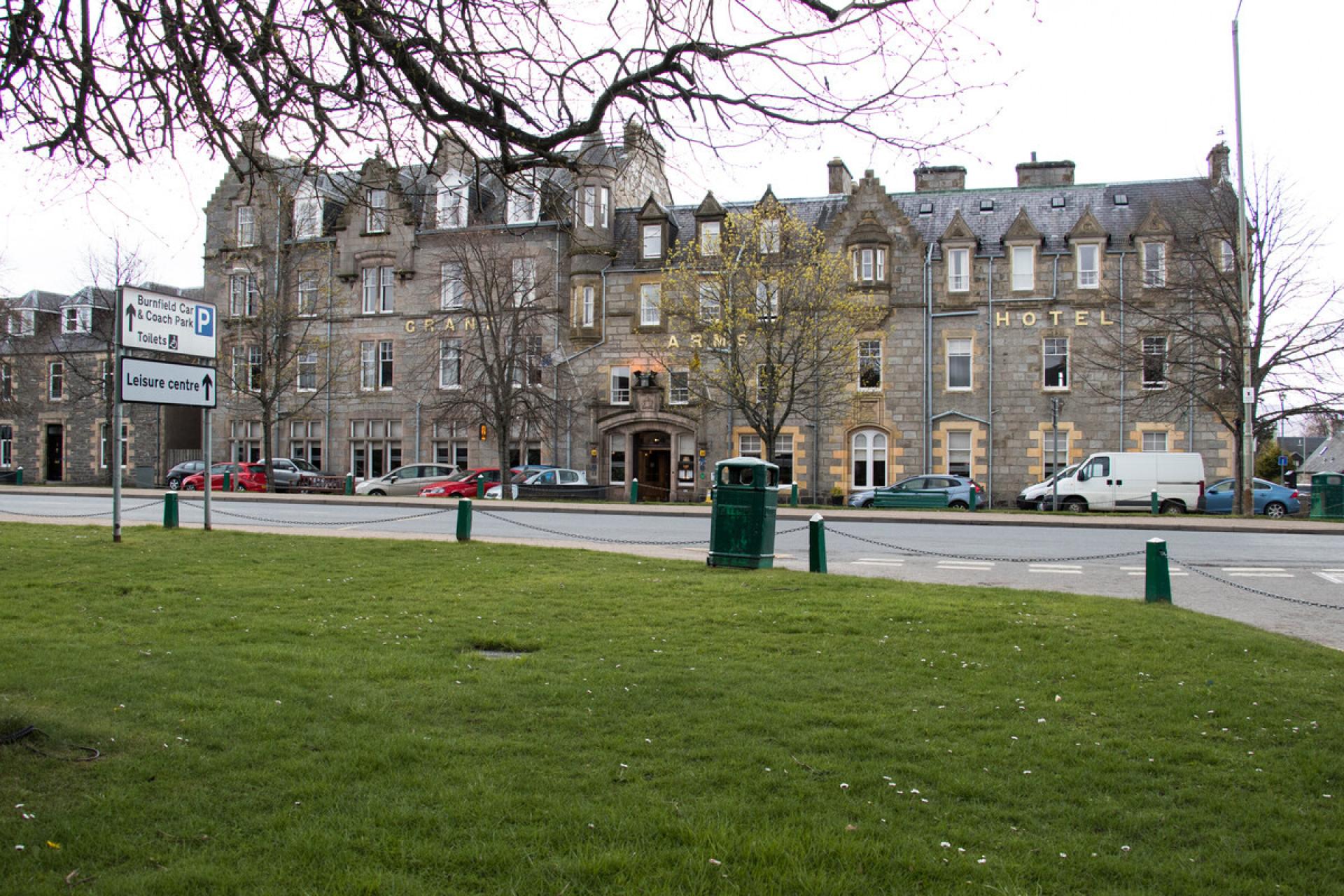 The Grant Arms Hotel in Grantown-on-Spey with grass in the foreground.