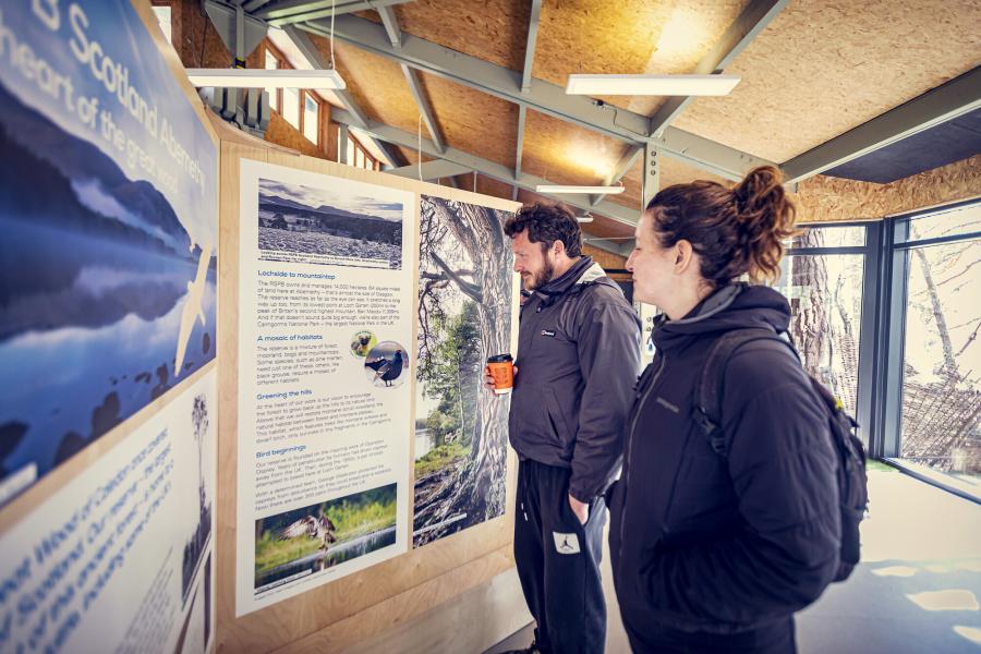 Two people reading information at the RSPB visitor centre