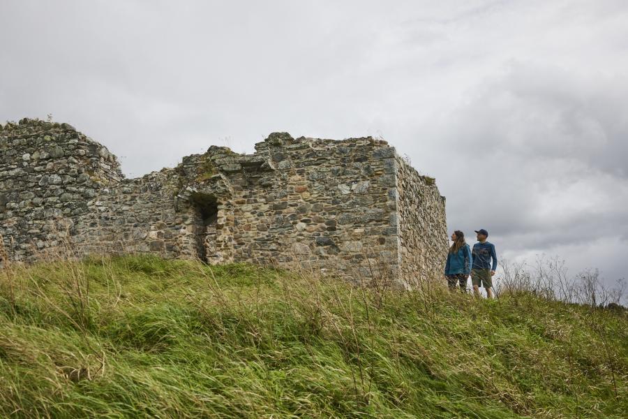 Two people explore Castle Roy in the Cairngorms National Park