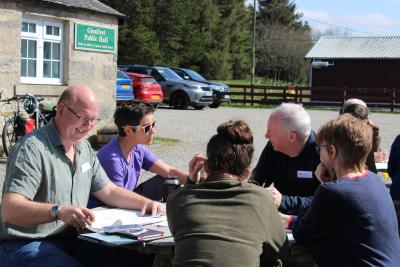 Members of the Cairngorms 2030 Communities Fund design panel sitting outside.