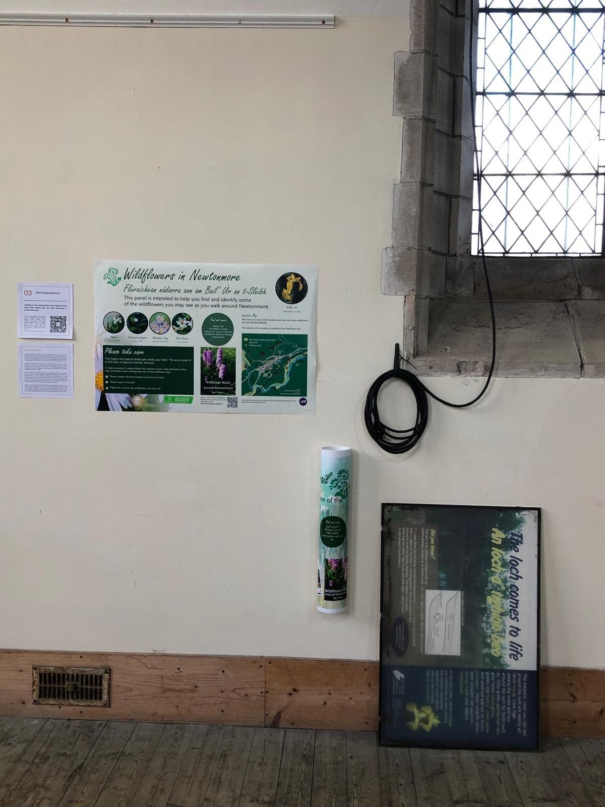 A room with a window and information panels on the wall