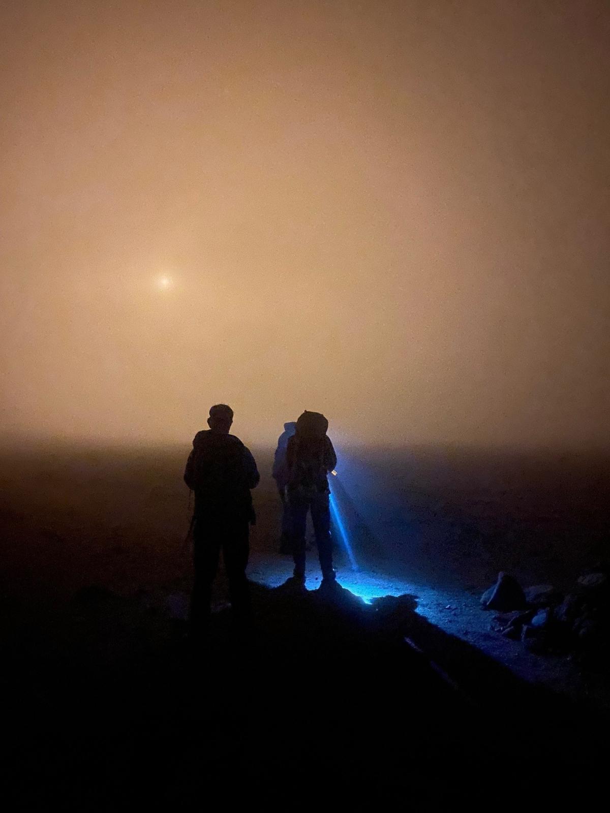 members of the mountain rescue using torches to search for lost walkers on Ben Macdui.