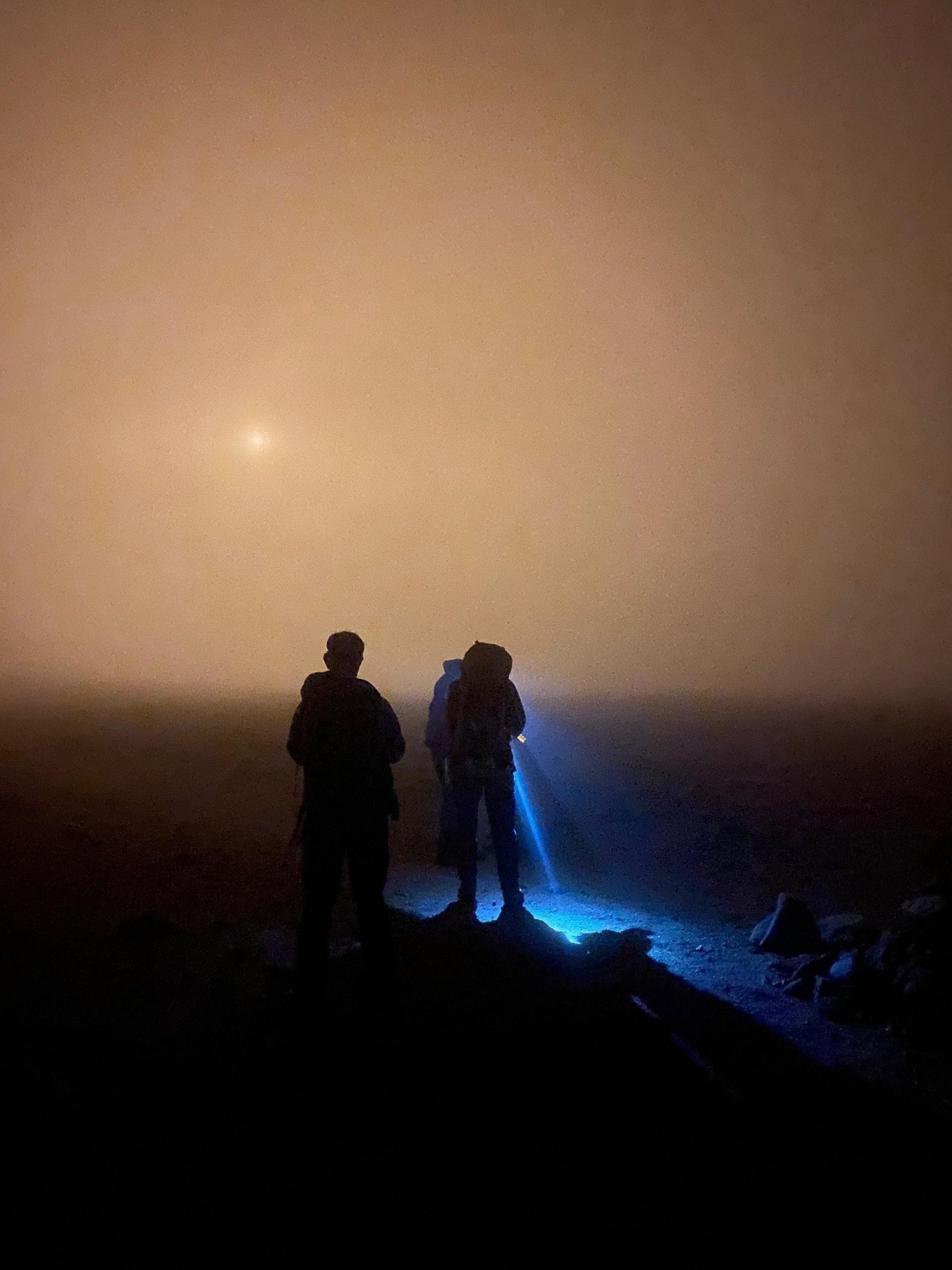 members of the mountain rescue using torches to search for lost walkers on Ben Macdui.