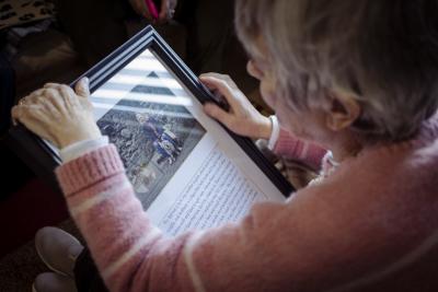 Person looking at a framed picture.