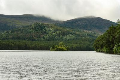 A view over water with hills and low cloud