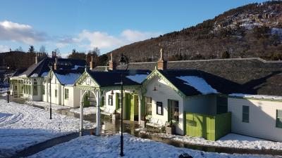 A snow covered old railway station with a cold winter sky