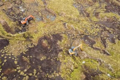 Two diggers working on peatland