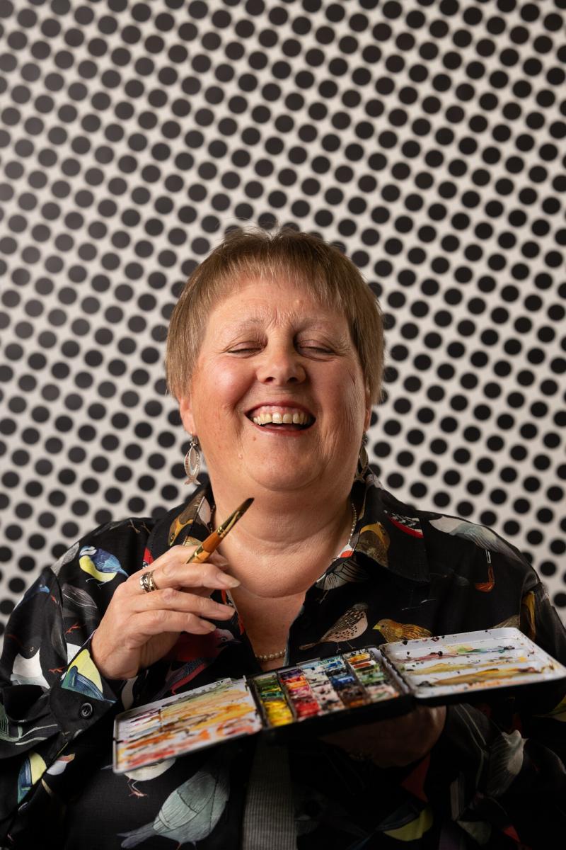 Female holding paint pallet and brush