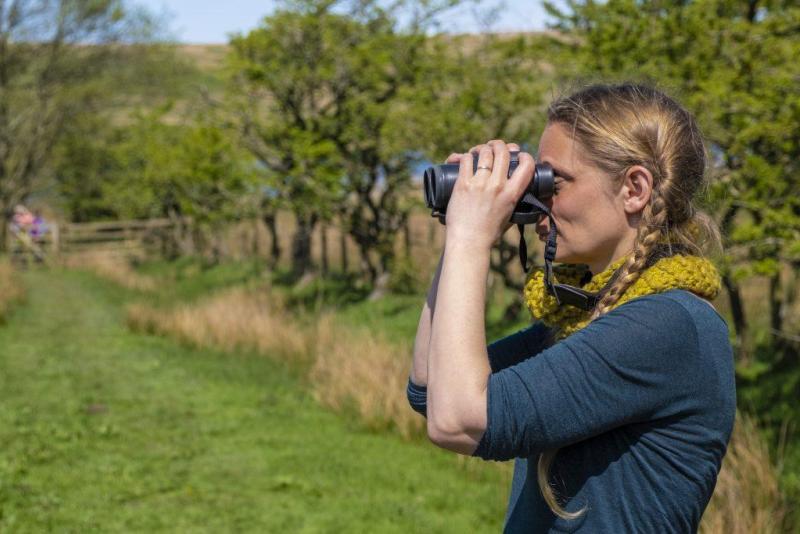 Person looking through binoculars.