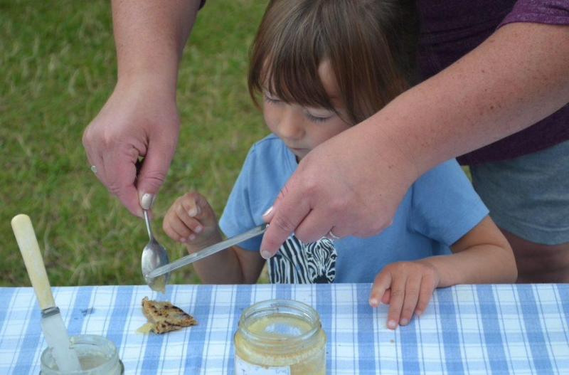 A girl preparing to eat her first bannock!