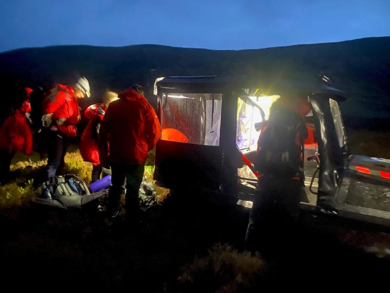 Mountain rescue members next to their transport