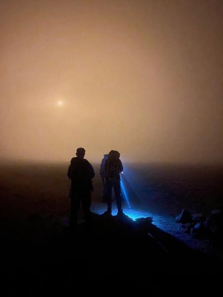 members of the mountain rescue using torches to search for lost walkers on Ben Macdui.