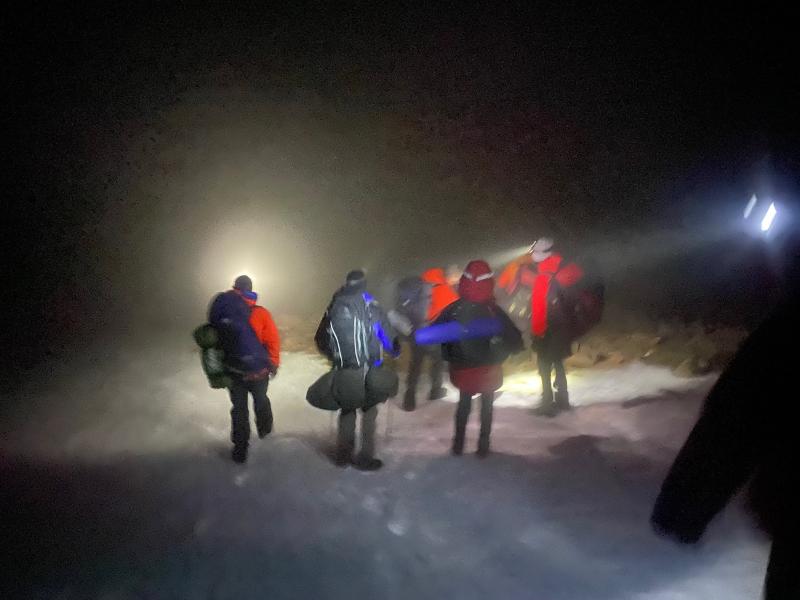 Mountain rescue members and lost walkers descending form ben Macdui