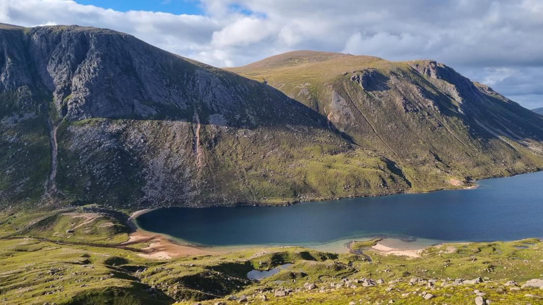 Image of a mountain with shadows and a loch below