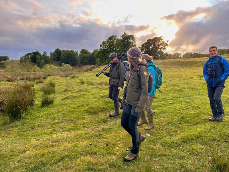 A group of four people walking down a hill