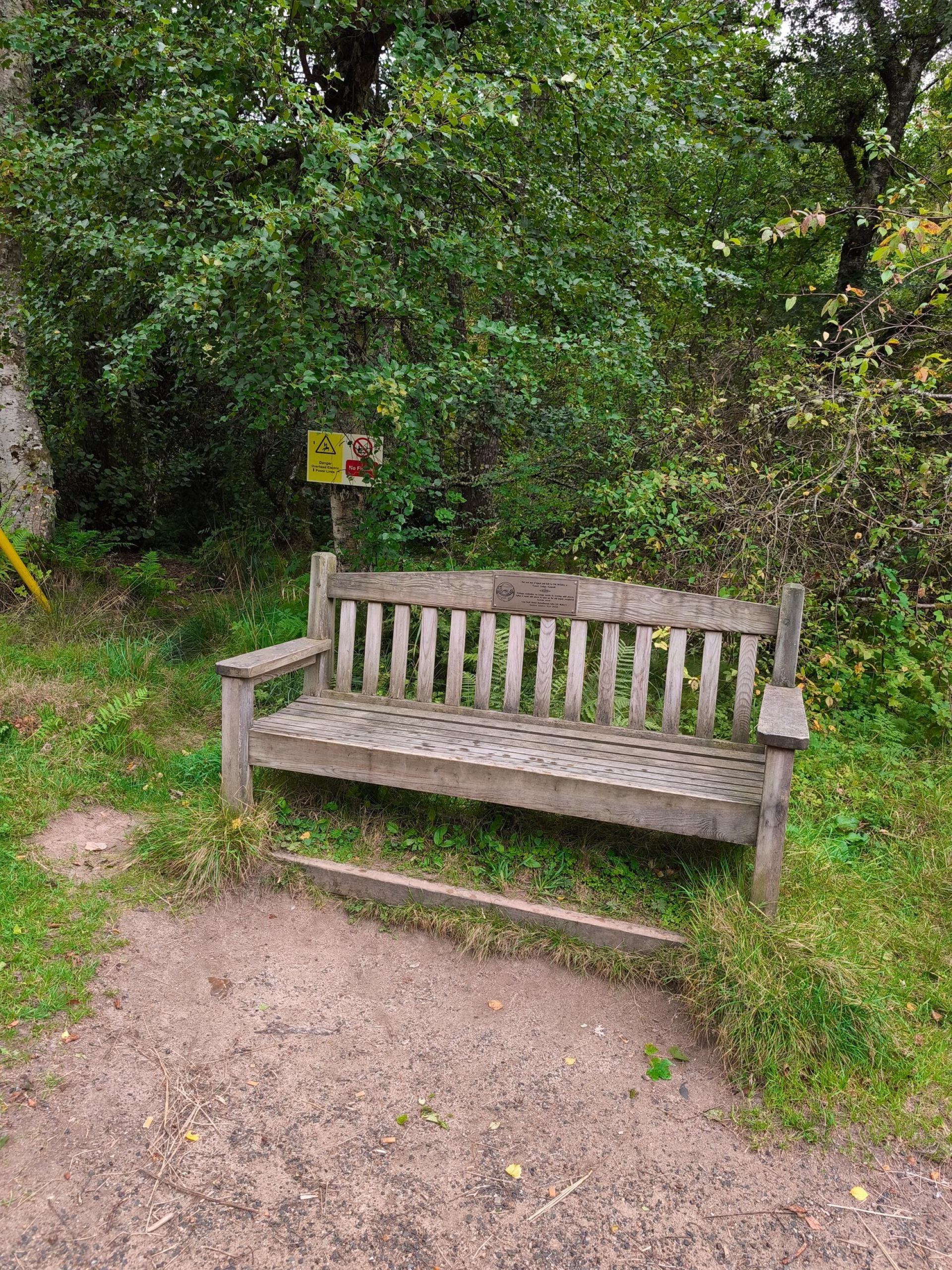 A wooden bench on the Riverside Trail in Nethy Bridge.