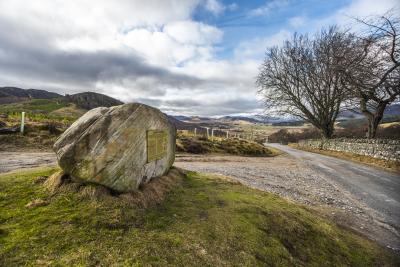 Centre of Scotland Stone and the road heading south.