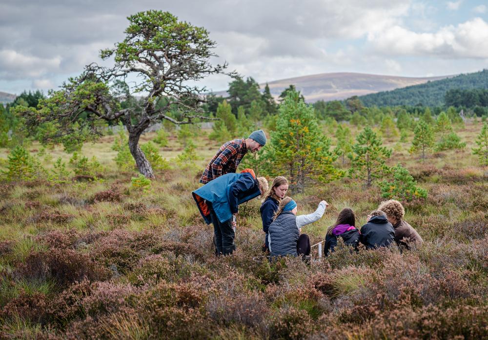 Park Authority Ranger Polly and Cairngorms Connect Community Learning Officer Lotte show pupils from Grantown Grammar how to monitor peatland.