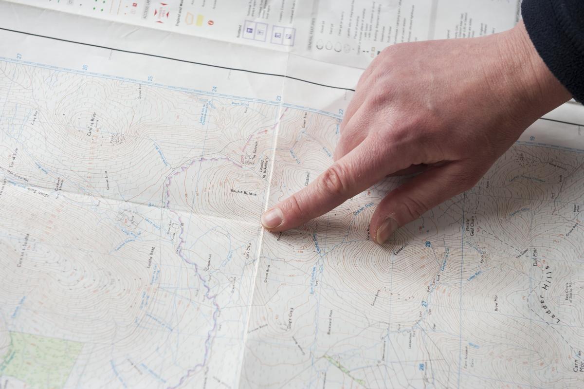 A hand, pointing at a map