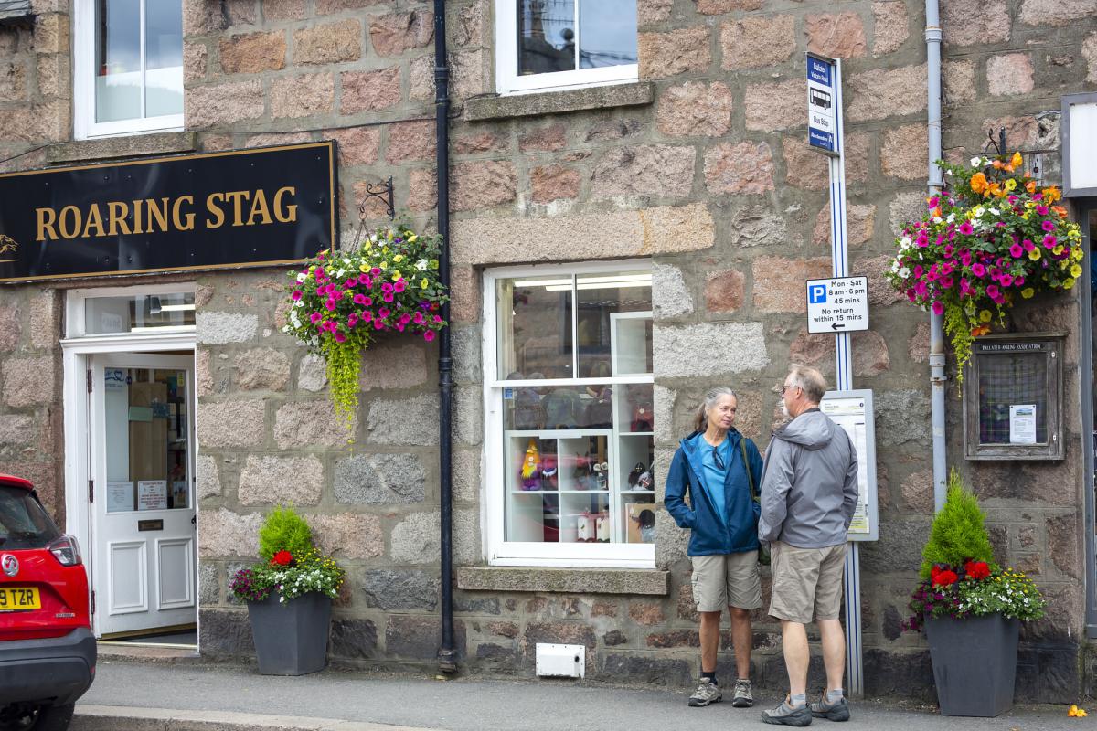 People waiting at a bus stop sign