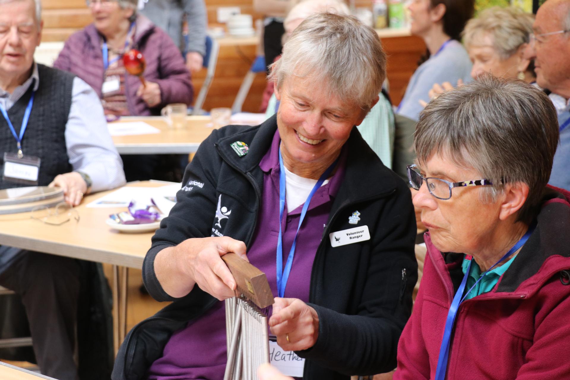 Two people playing wind chimes