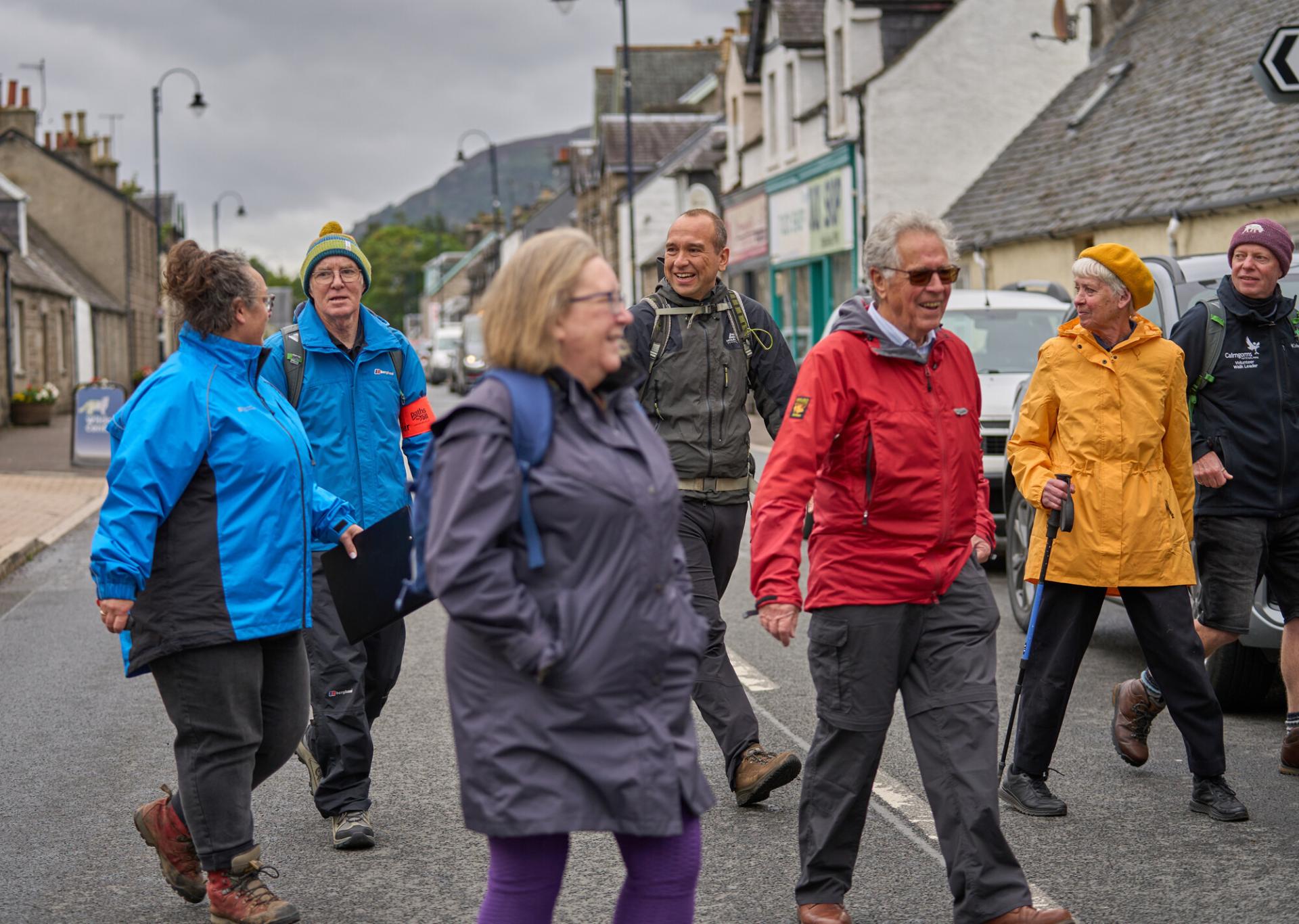 A group of people crossing the road on Newtonmore health walk