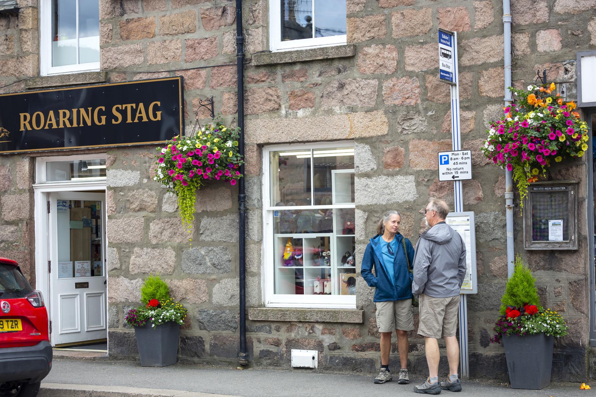 People waiting at a bus stop sign