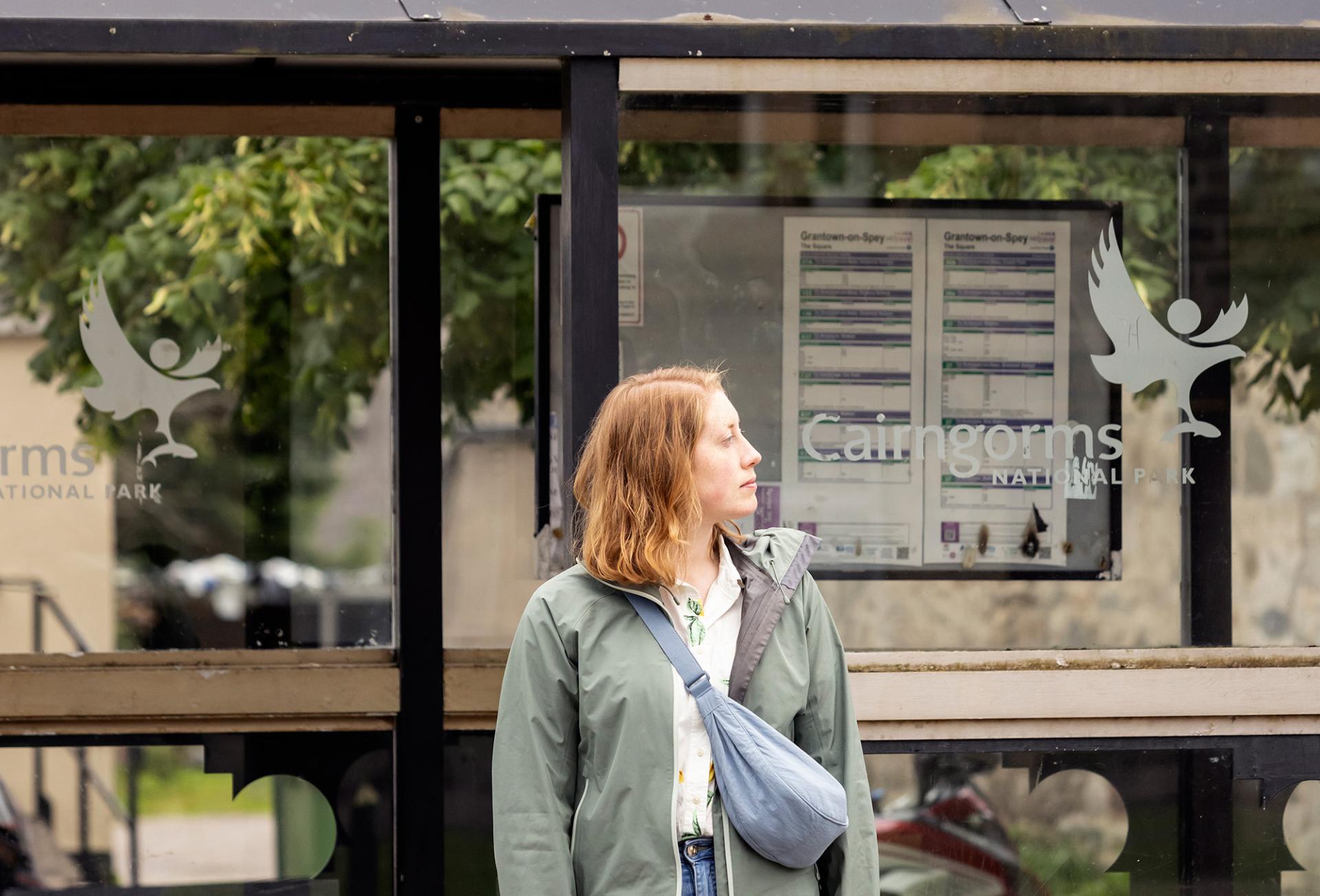 Person waiting at a Cairngorms National Park branded bus stop