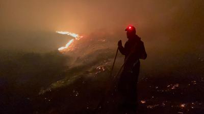 Person with PPE fighting the fire wearing a headtorch