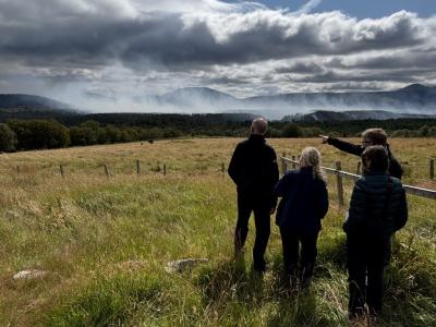 People point out fire smouldering on the hill