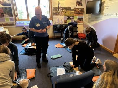Group of young people practising first aid in a room