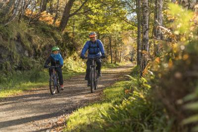 A father and son cycling a country path, Ballater