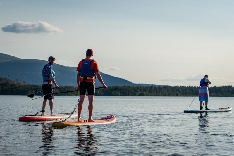 People paddleboarding on Loch Morlich