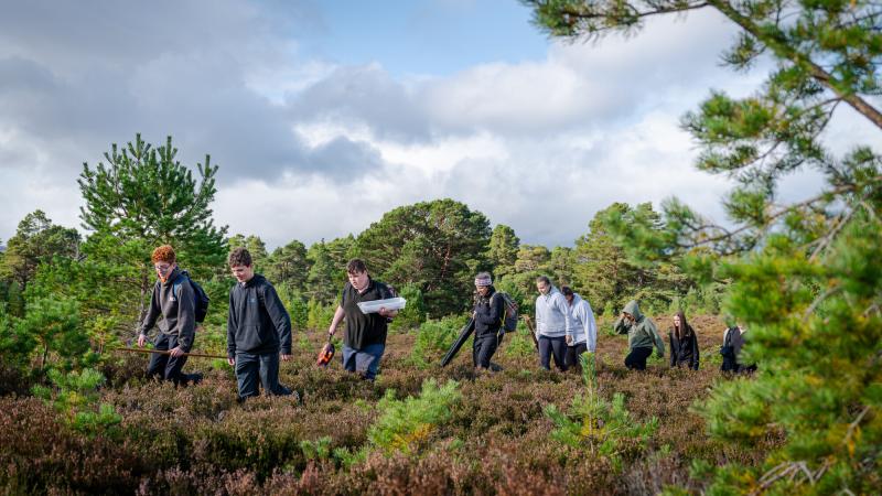 Park Authority Ranger Polly and Cairngorms Connect Community Learning Officer Lotte show pupils from Grantown Grammar how to monitor peatland.