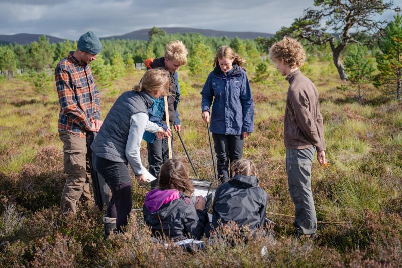 Rangers showing school pupils how to monitor peatland