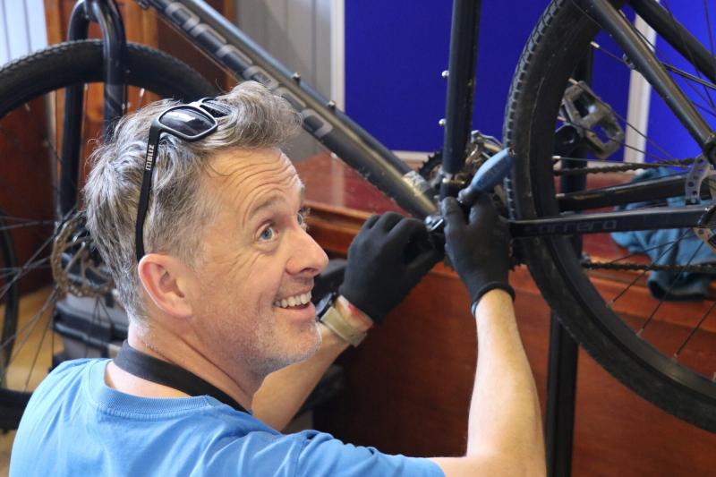 A person fixing a bike at a C2030 event in Carrbridge.
