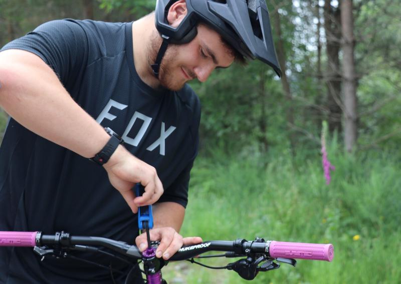 Josh tightening the handlebars of his bike