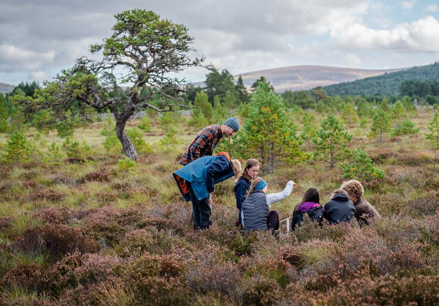 Park Authority Ranger Polly and Cairngorms Connect Community Learning Officer Lotte show pupils from Grantown Grammar how to monitor peatland.
