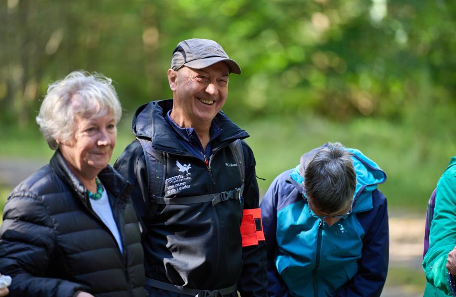 Health walk leader and walkers in Anagach woods in Grantown-on-Spey.