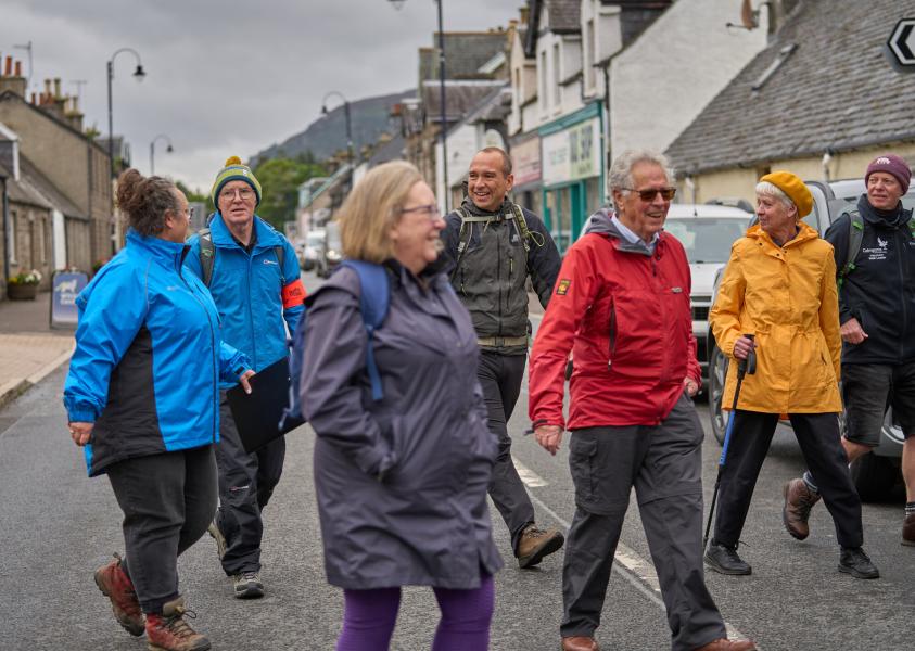 A group of people crossing the road on Newtonmore health walk