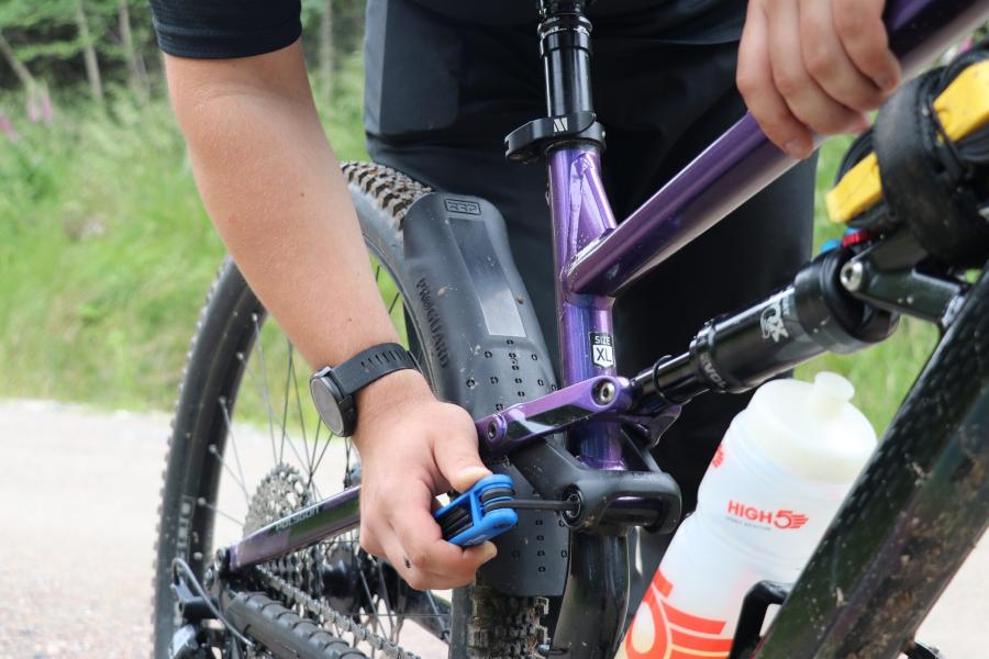 Josh fixing his bike at the side of the trail.