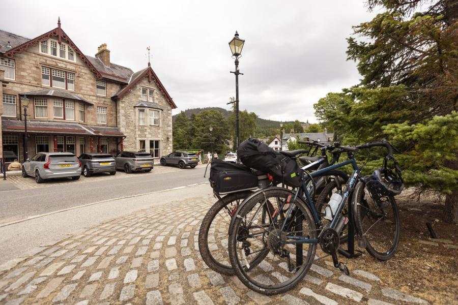 Bikes on a bike stand next to a pavement